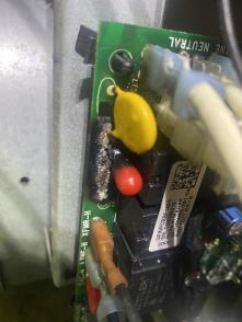 Picture of a Bailey's Comfort Services techician fixing the furnace control board